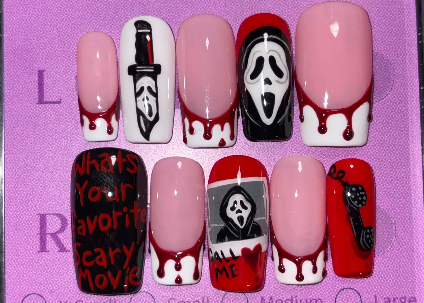 Set of Halloween-themed nail designs in a display case with 'AmiEZ Nails' branding.
