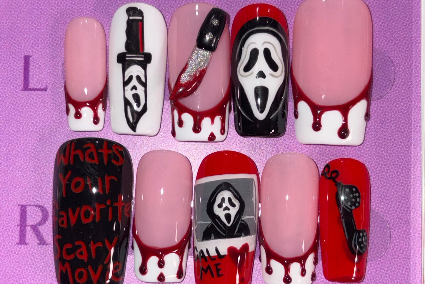 Set of Halloween-themed false nails in a clear case with a purple label.