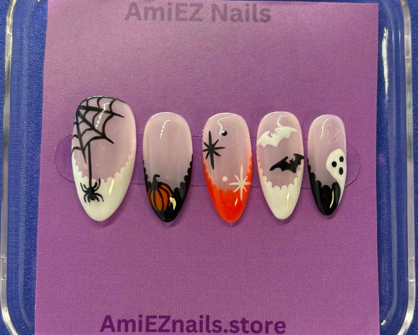 Set of Halloween-themed false nails in a clear case on a purple card with 'AmiEZ Nails' branding.
